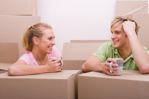 Local removals team handling furniture in a West Ham flat