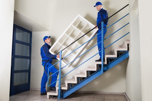 Removal team preparing a move in West Ham street with residential buildings