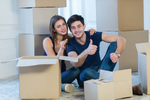 Trained moving staff using safe lifting methods during a house move